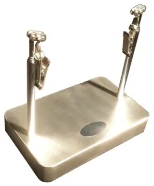 A silver stand with two metal pens on top of it.