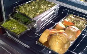 A close up of food in trays on top of a counter.