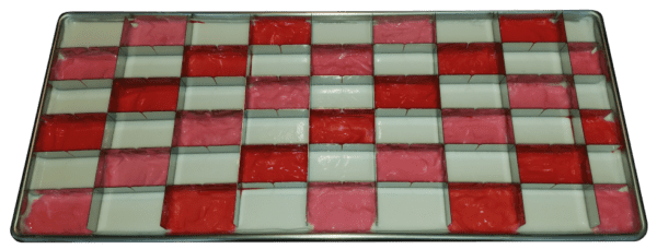 A tray of red and white squares on top of a table.