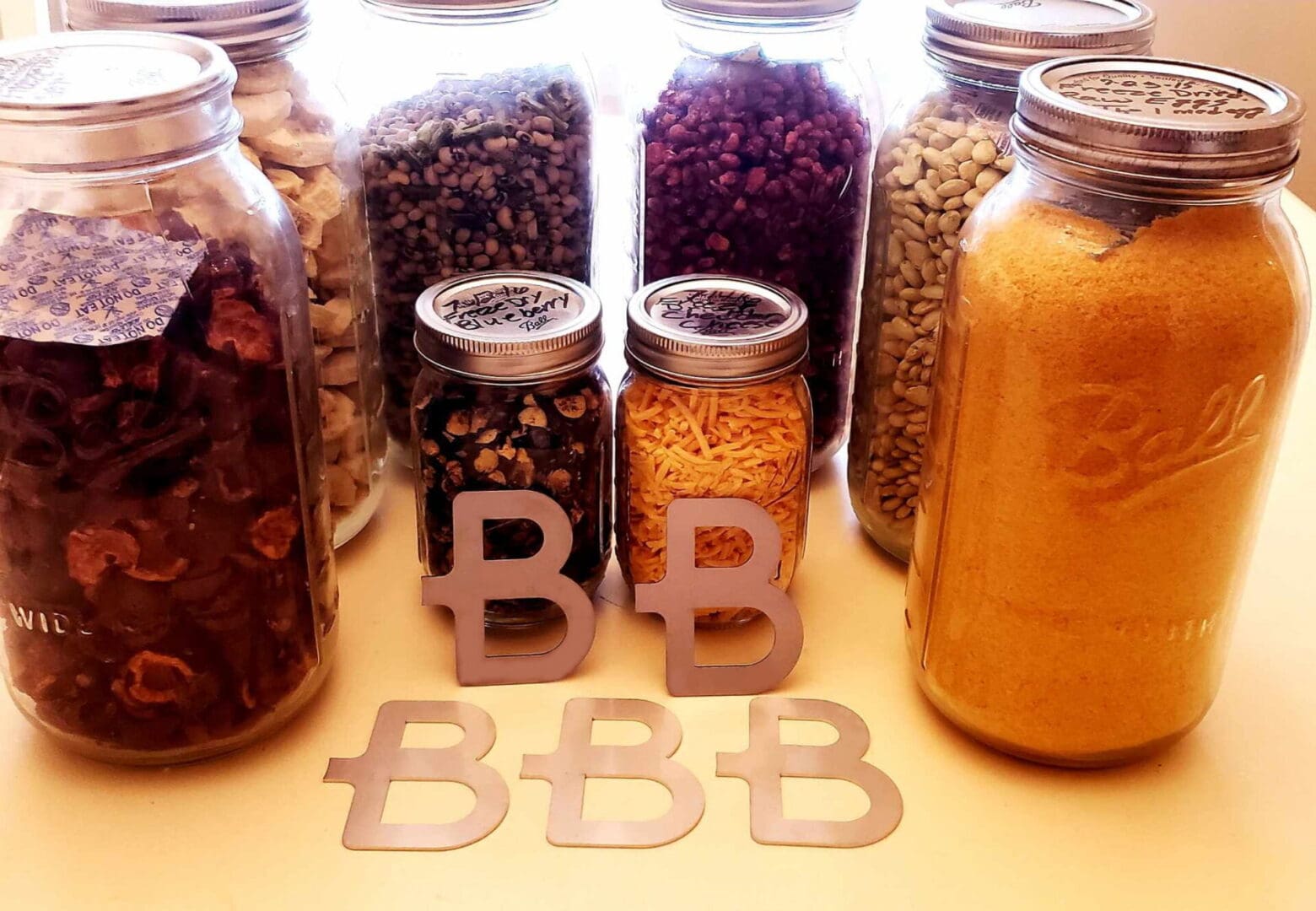 A table with jars of different foods and some letters