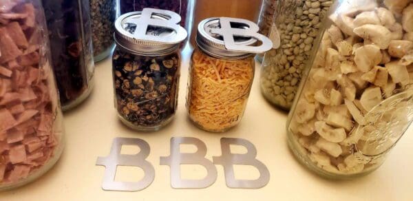 A table with two jars of food and the letters bbb