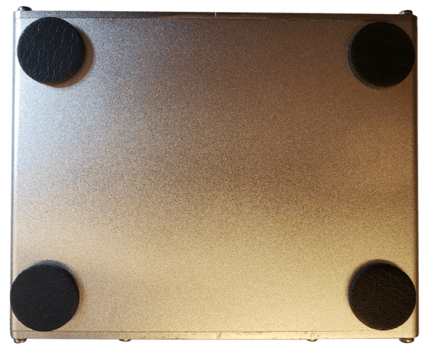 A metal plate with four black circles on it.