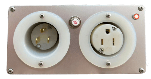 Two electrical sockets mounted on a metal plate, labeled "15," with three-pronged and two-pronged plug outlets, along with a small red light indicator in the top right corner. Ideal for any Cable Cooler setup.