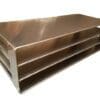 A metal shelf with three levels sitting on top of it.