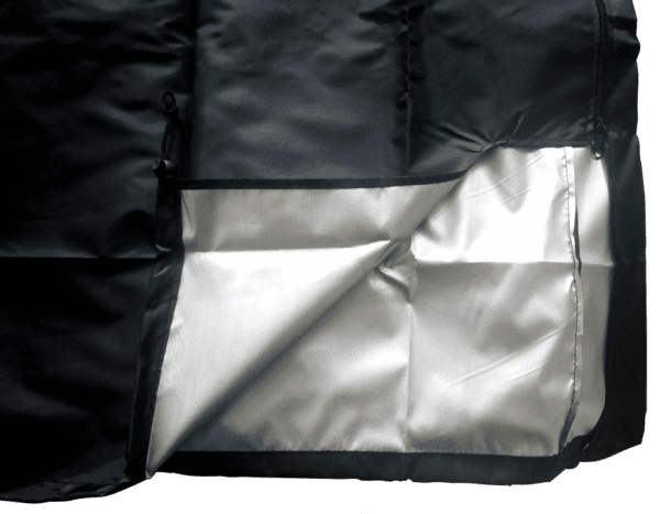 A black and silver blanket with a white sheet.