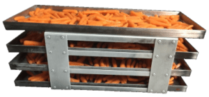 A metal tray filled with carrots on top of a table.